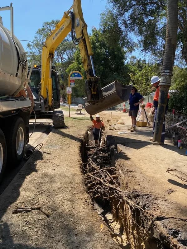 VACIT crew working beside an excavator and vacuum truck